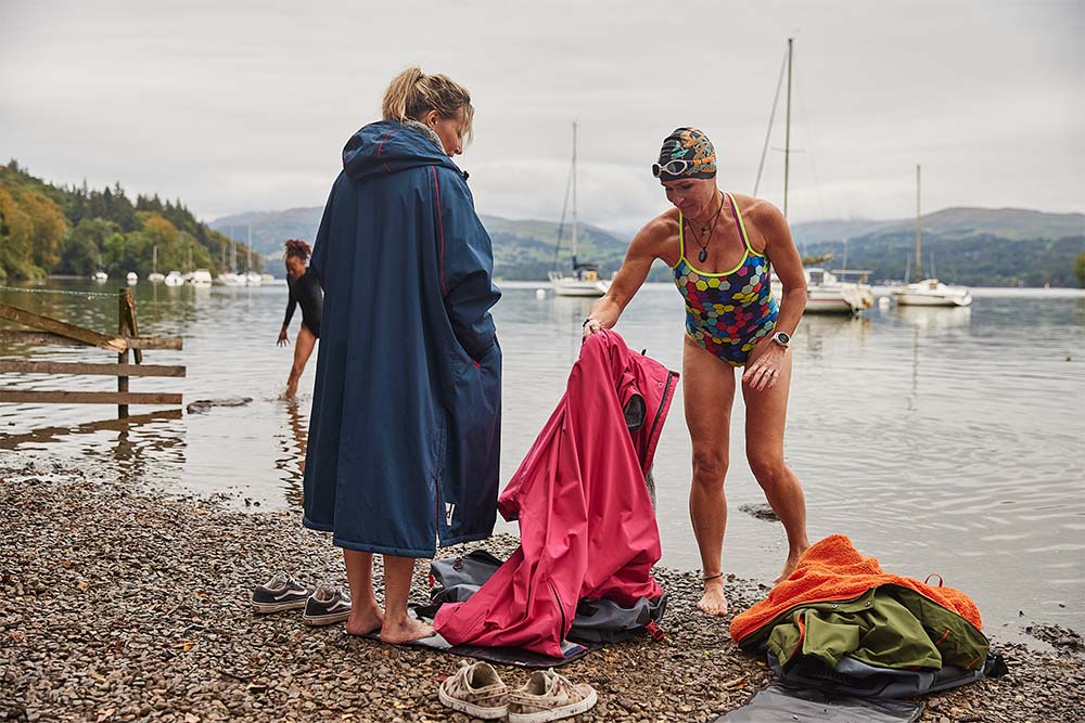 Women swimming putting on Red Original waterproof changing robe