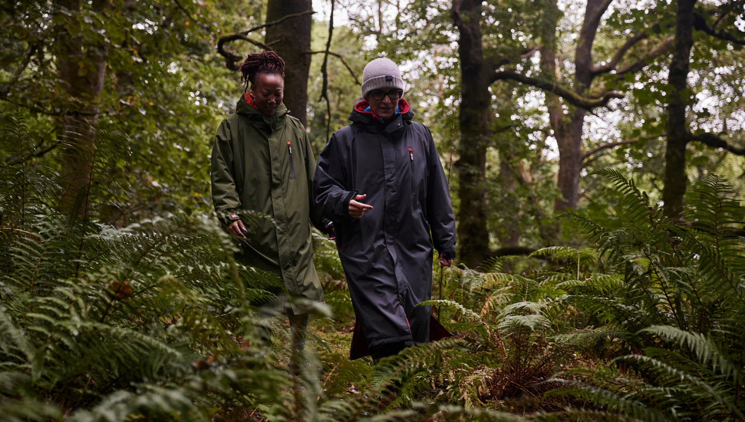 2 people walking through the forest in their Red Change Robe