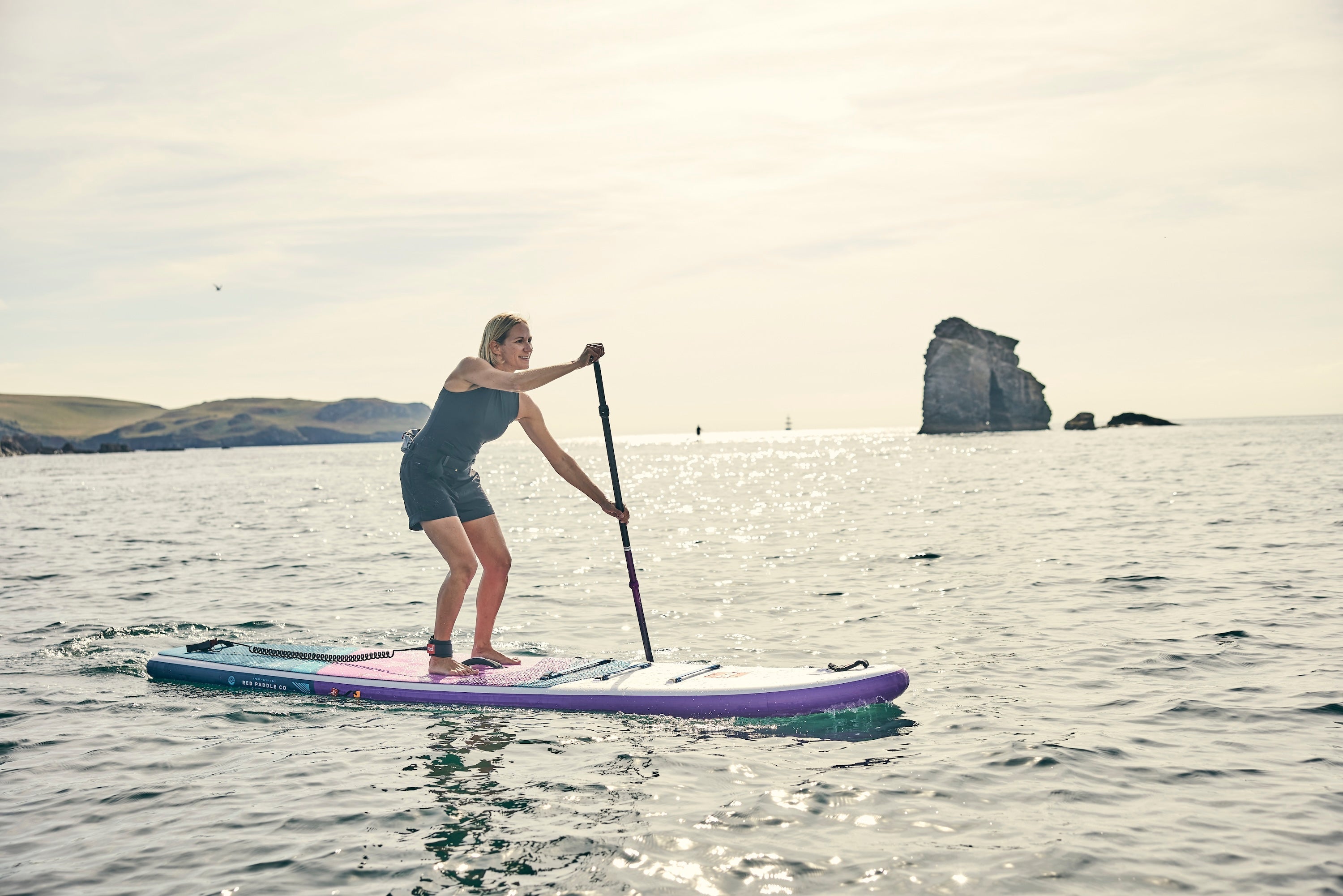 Woman paddleboarding at South Milton Sands