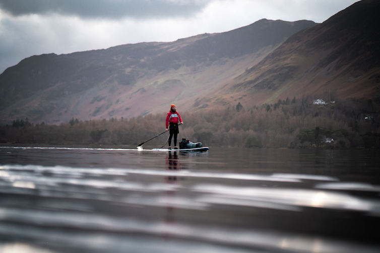 Paddle boarding on a fast flowing River