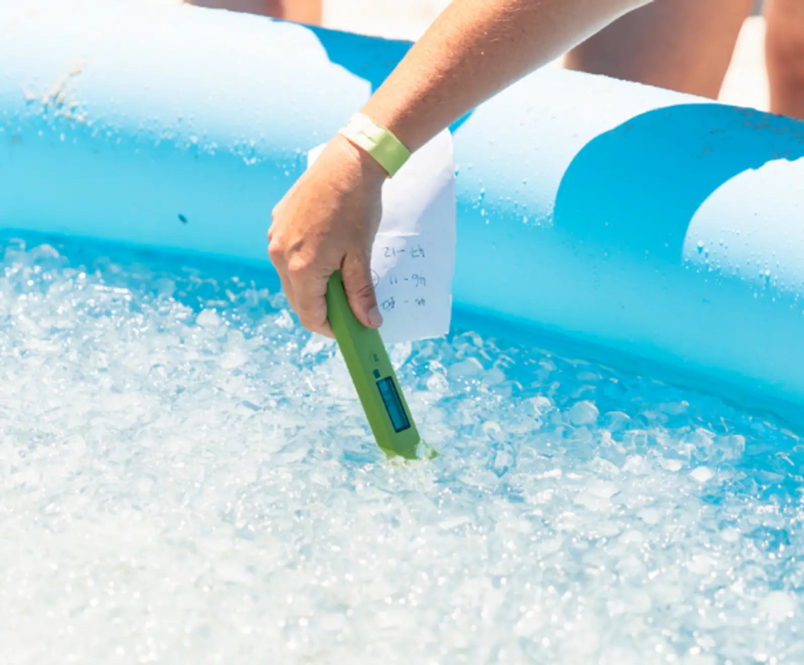 Someone testing the temperature of an ice bath