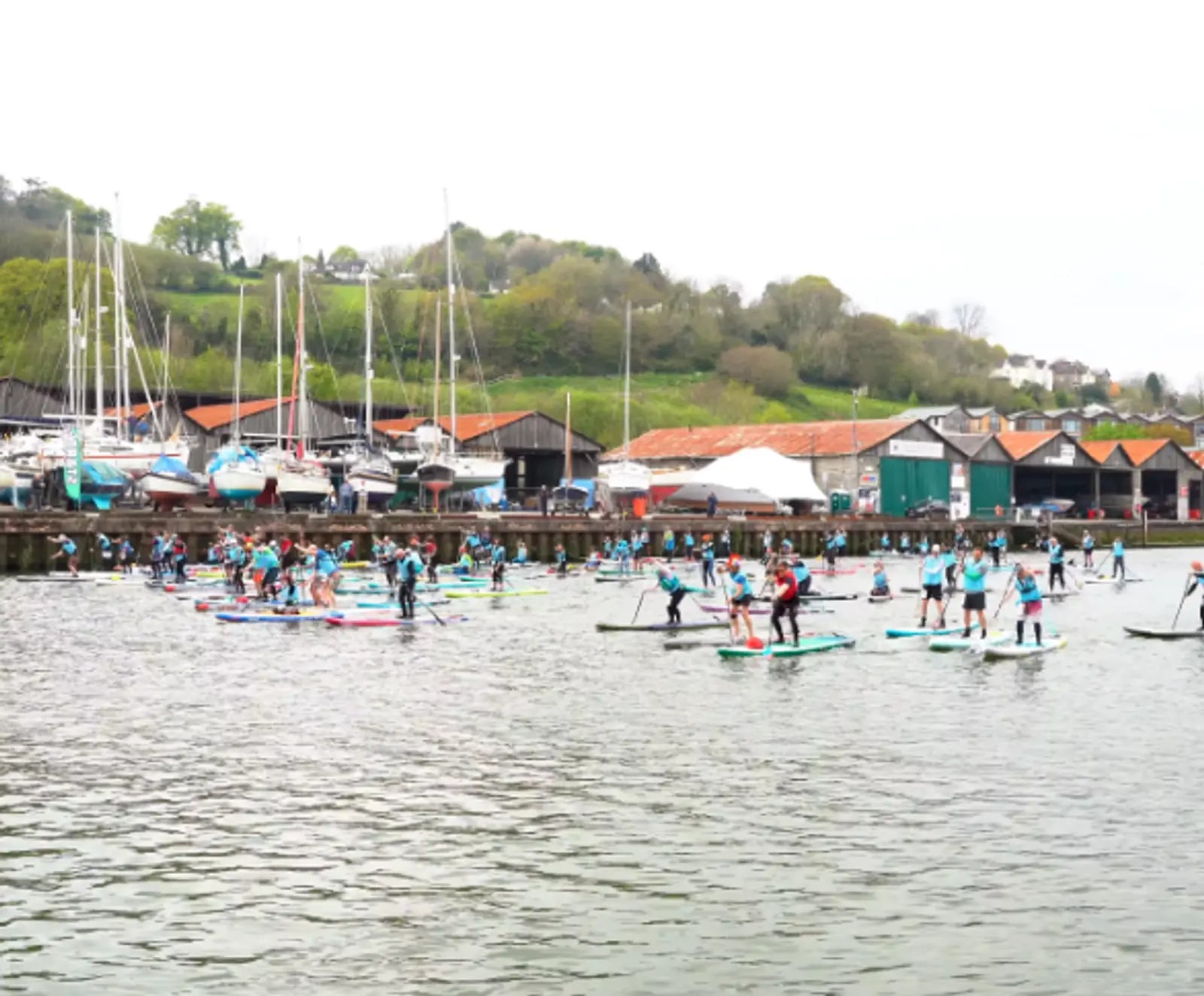 A group of people participating in a paddleboard race