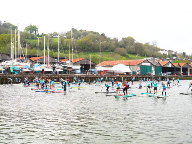 A group of people participating in a paddleboard race