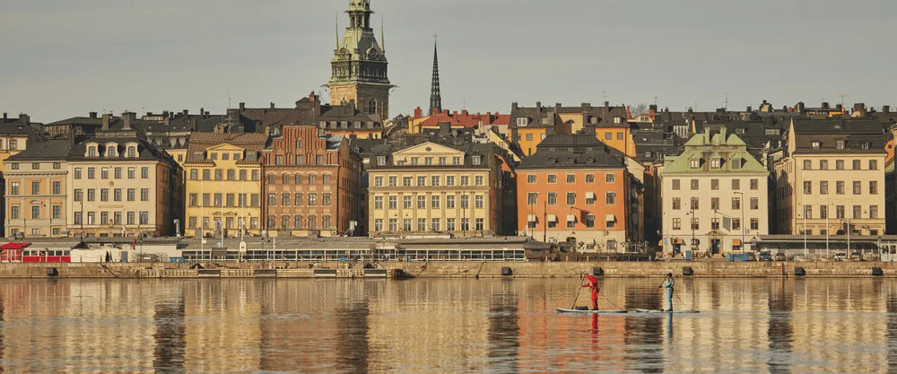 2 people paddleboarding in a canal