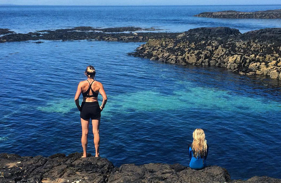 mother and child look out to sea