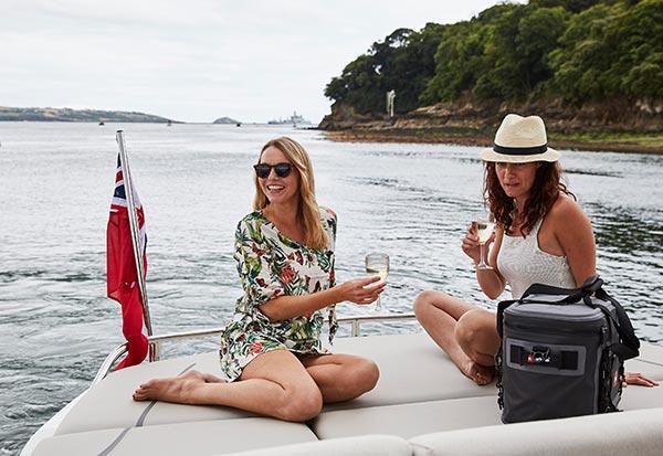 two women sat on the back of a boat