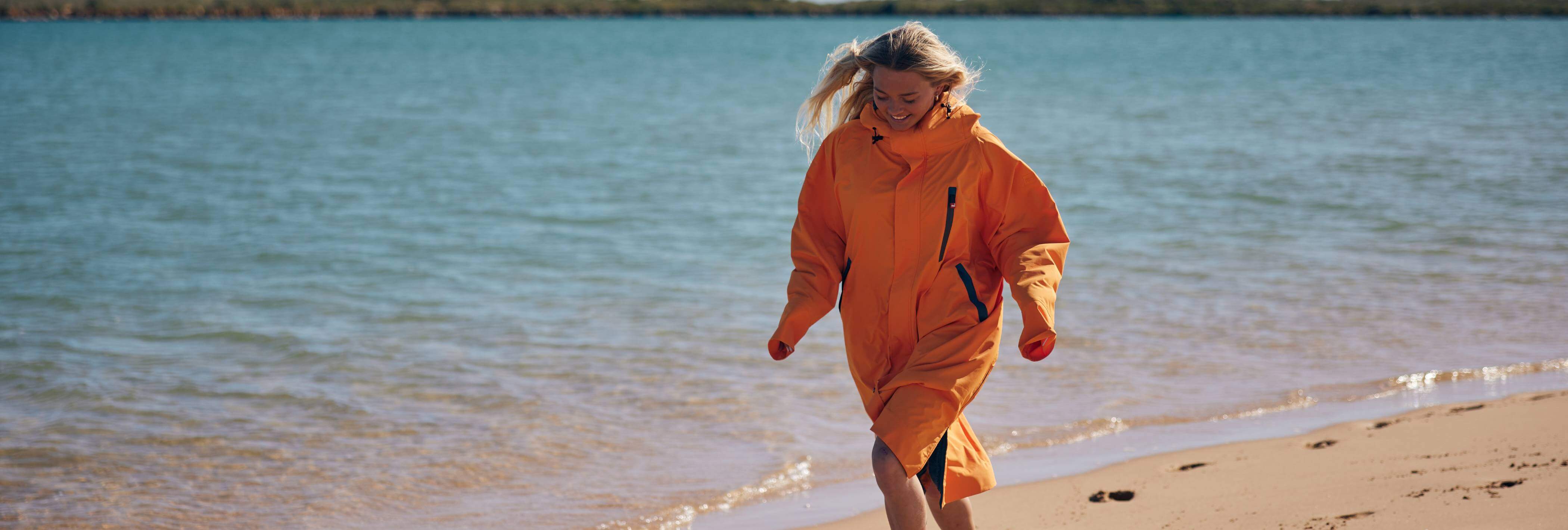 woman on beach wearing changing robe