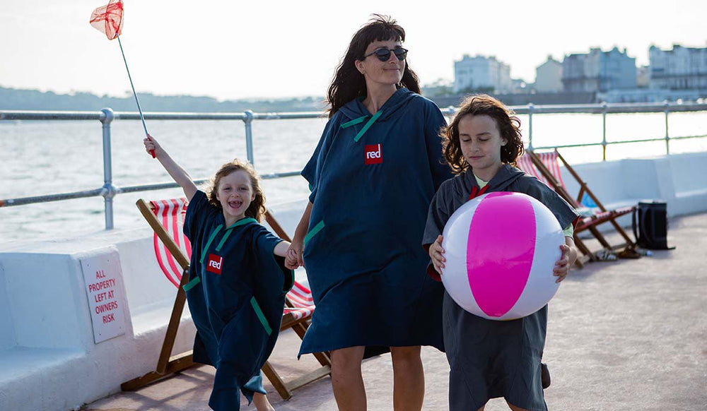 2 girls and their mother walking along a promenade