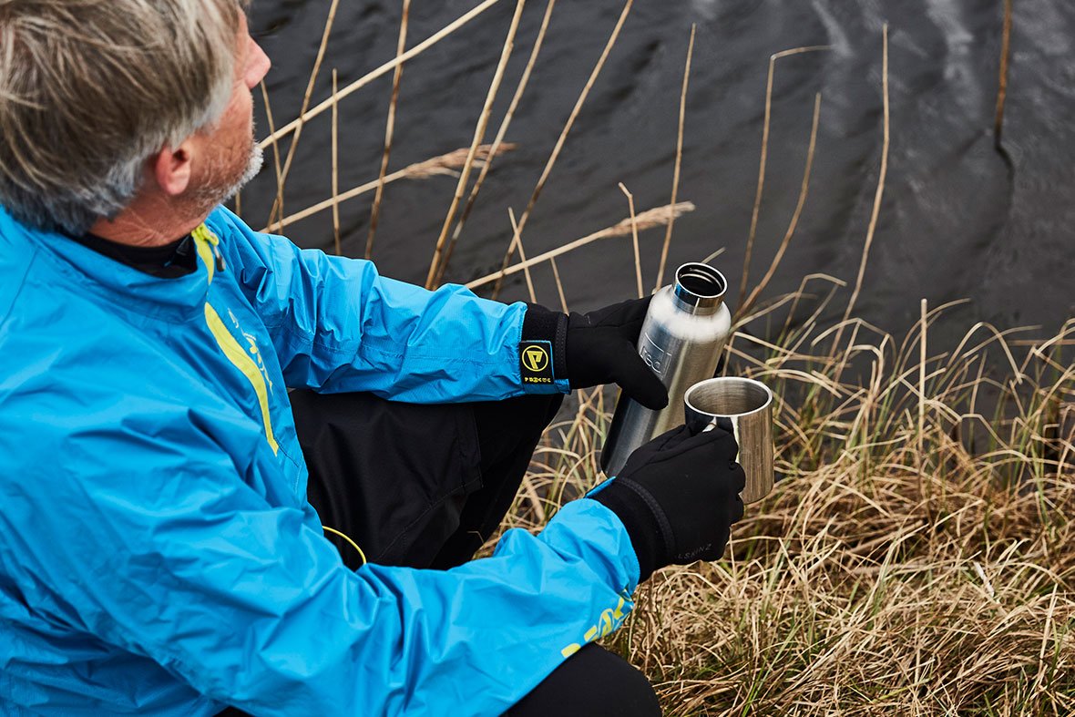 man drinking out of red originals water bottle