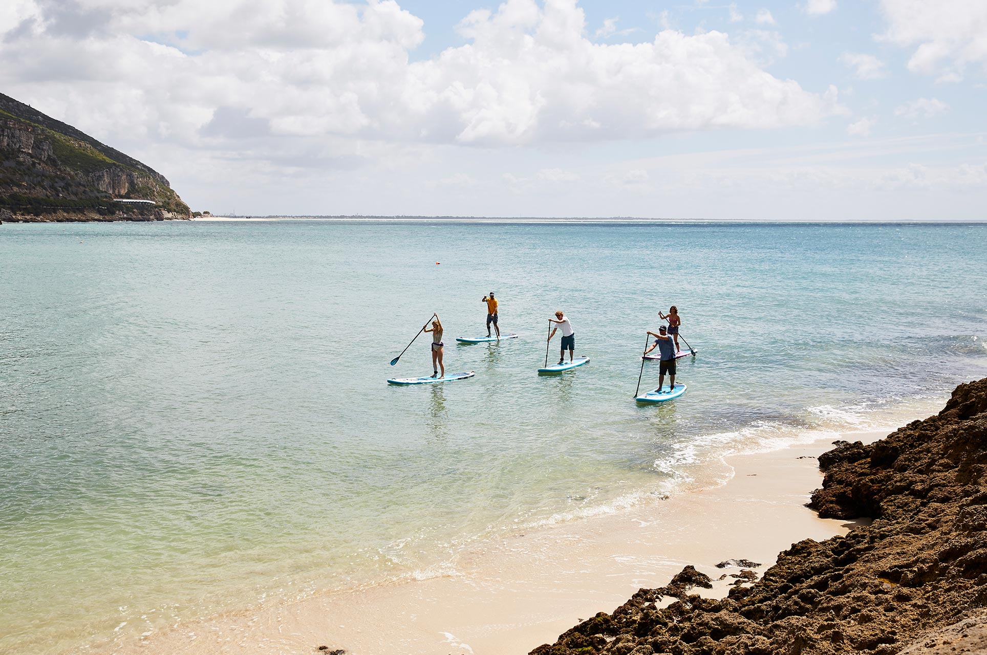 People Paddle Boarding In The Sea