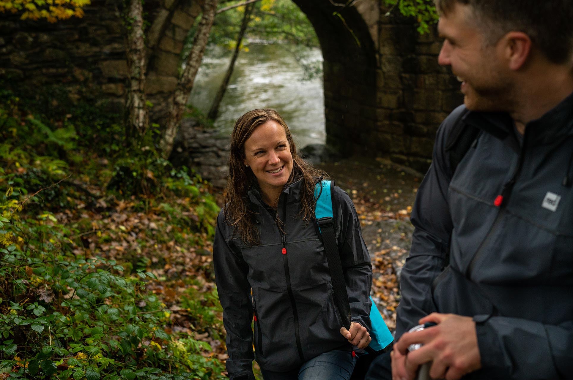 Woman looking longingly at man in a forest