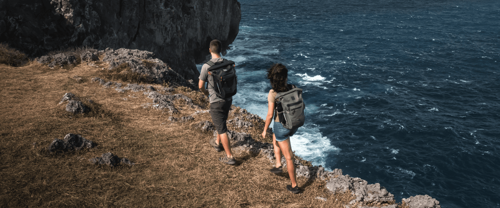 man and woman hiking wearing waterproof backpacks