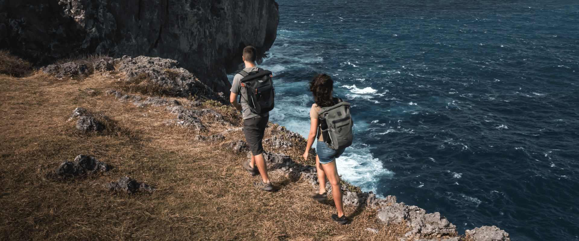 man and woman hiking wearing waterproof backpacks