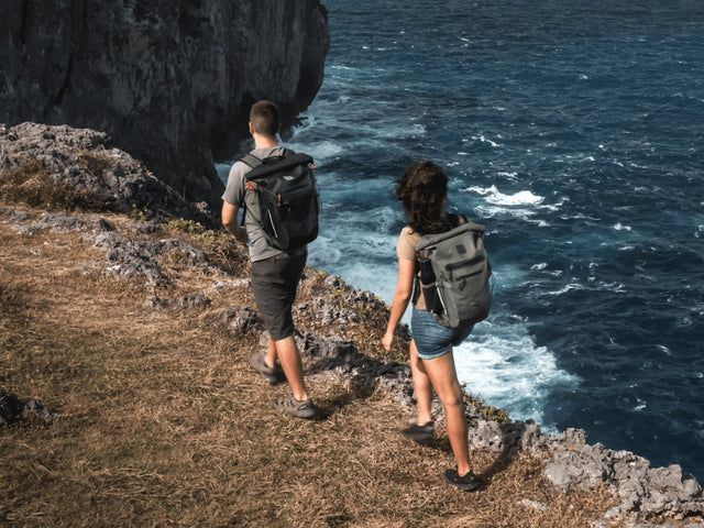 man and woman hiking wearing waterproof backpacks