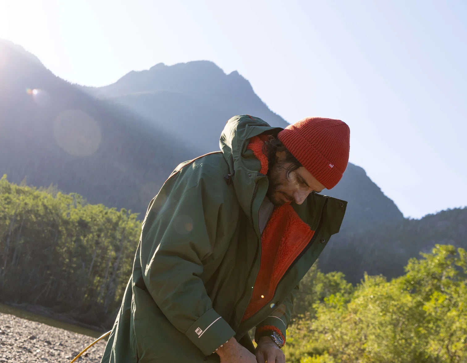 A man zipping up his changing robe whilst on a walk