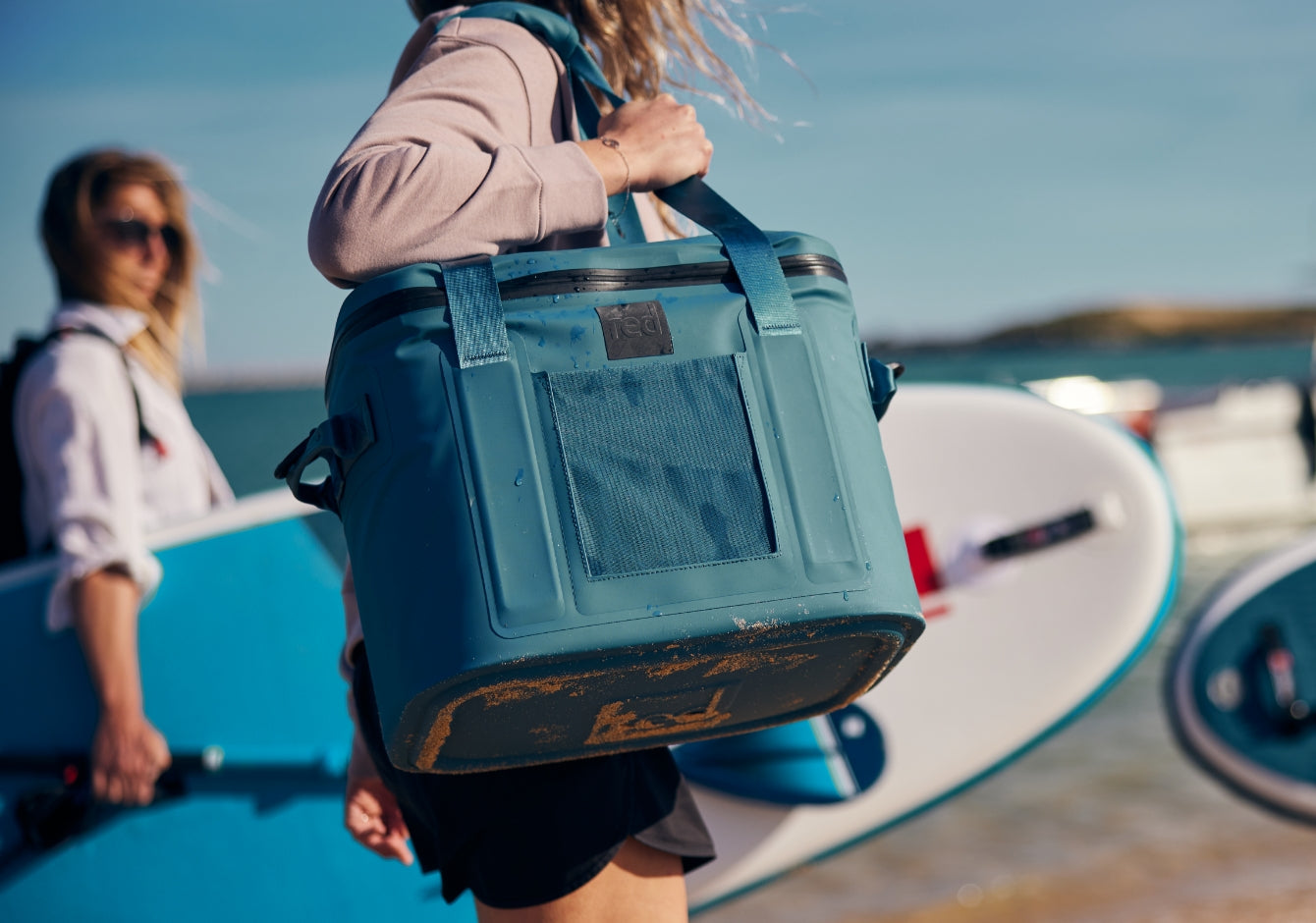 woman holding a waterproof cool bag on the beach