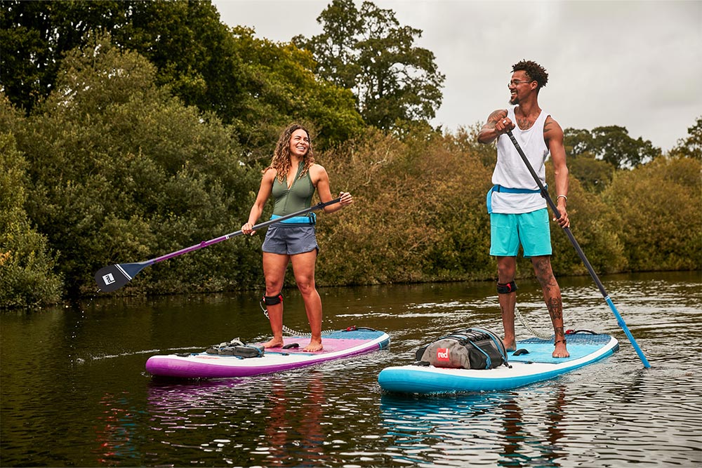 Man and woman paddling Red Original 10'6 compact MSL paddle boards