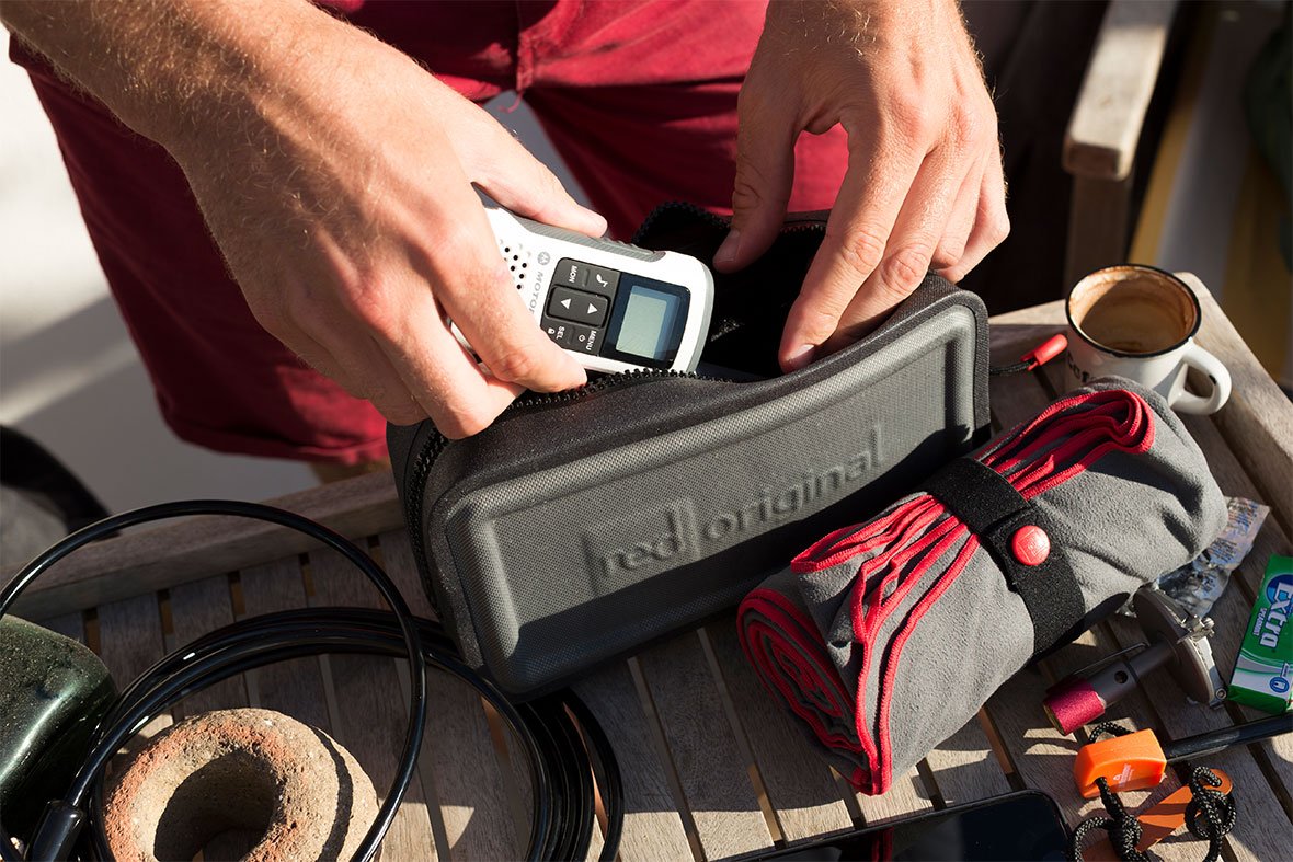 man packing safety kit on boat