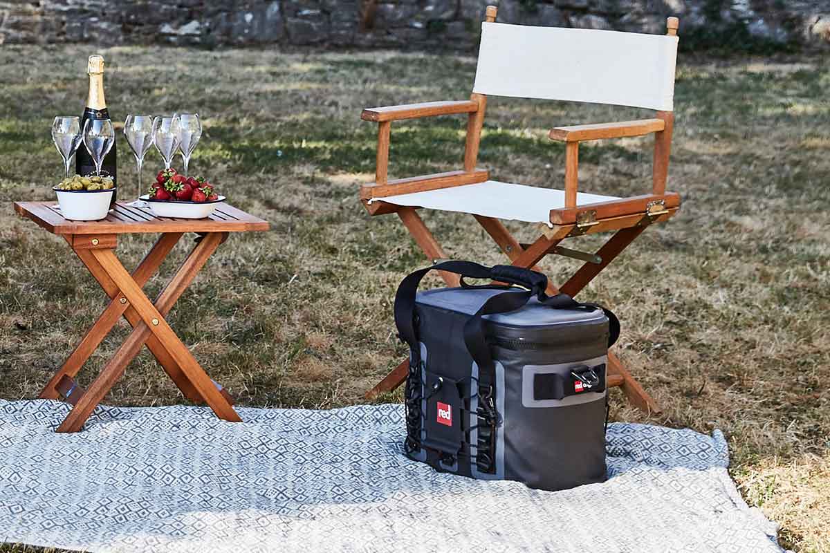 An Outdoor Picnic With folding chairs, a folding table, and a waterproof cooler bag