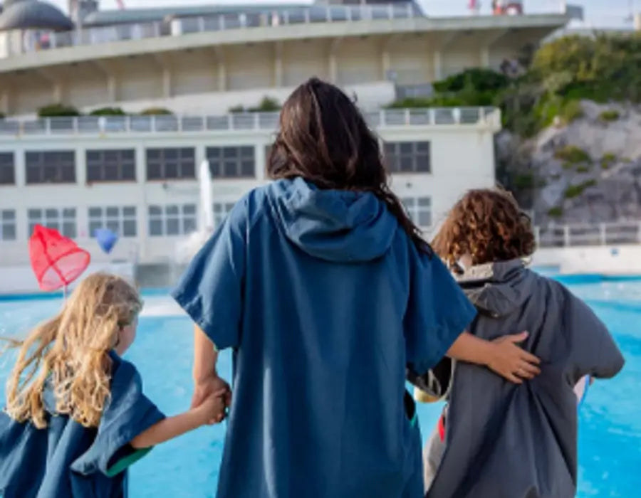 Woman with two children at a swimming pool.