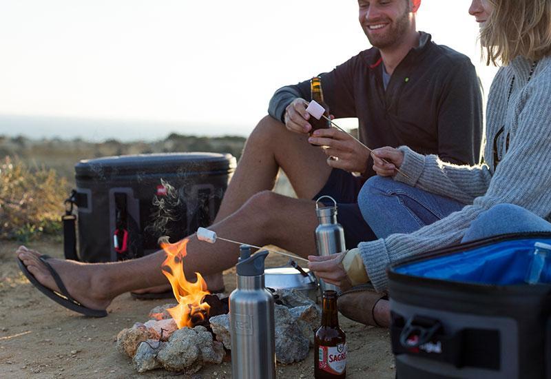 Couple having a picnic with a premium cooler bag nearby