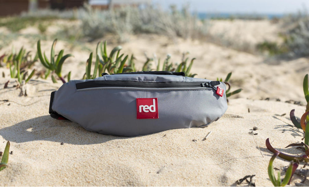 The Red Original Airbelf PFD On A Bed Of Sand