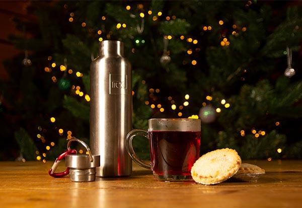 red original flask infront of Christmas tree