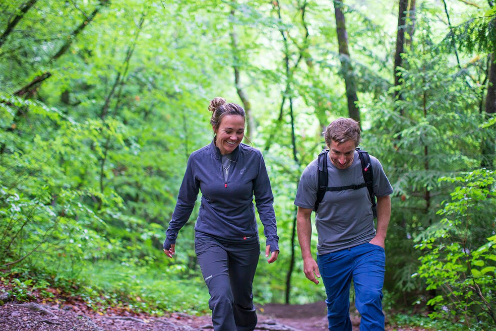 Couple Hiking Through A Forest