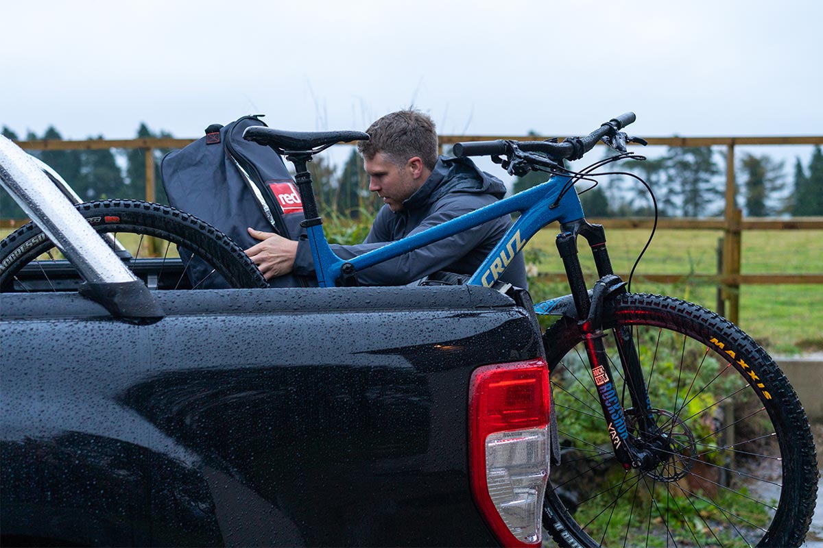 Man Attaching a go bag to his bike