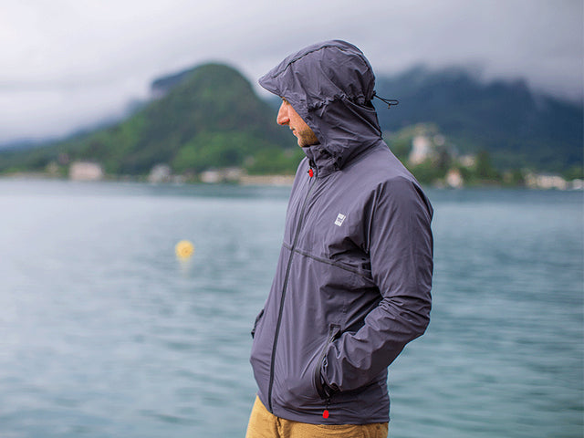 Man looking over the water at Lake Annecy wearing Red Original Men's Waterproof Active Jacket